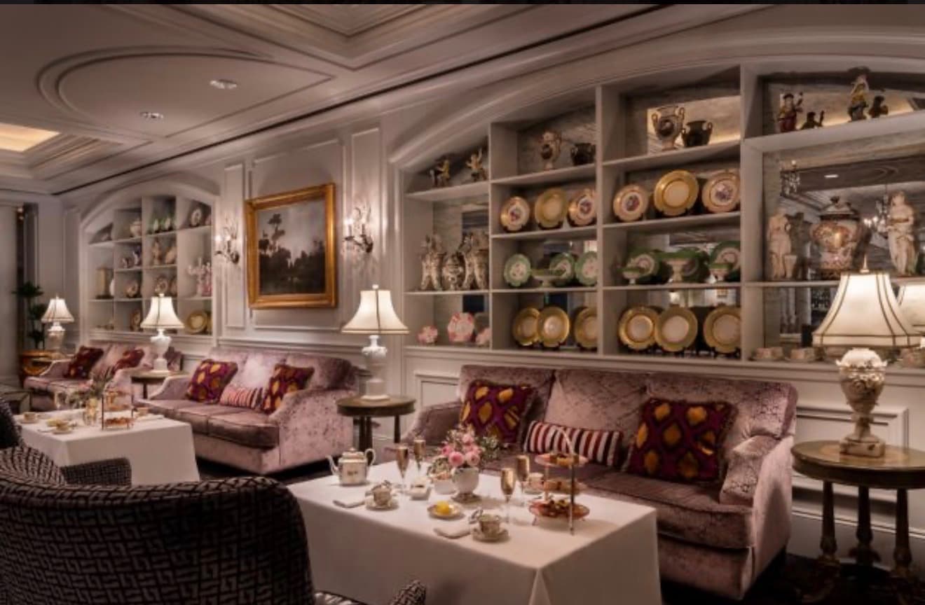 The tea salon with gold-rimmed china and velvet sofas